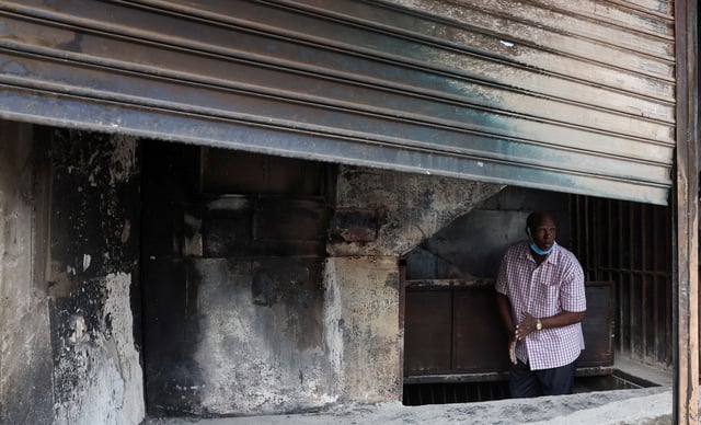A trader stands inside his business premise, burnt during demonstrations to mark the first anniversary of the deadly 2024 anti-government protests that drew widespread condemnation over the use of force by security agencies, in downtown Nairobi, Kenya June 26, 2025. REUTERS/Monicah Mwangi