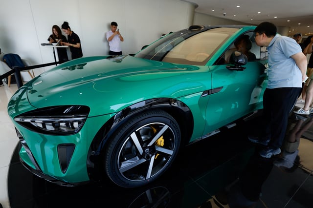 A person looks at the new electric SUV YU7 displayed at a Xiaomi store in Beijing, China May 29, 2025. REUTERS/Tingshu Wang/File Photo