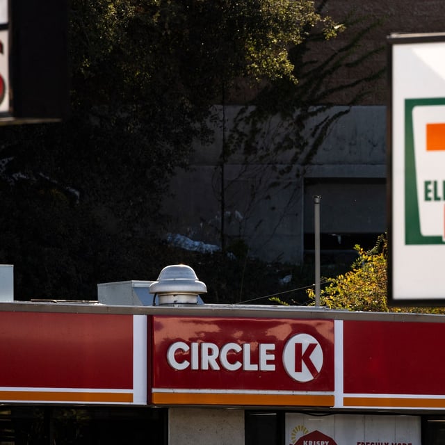 The signs of convenience stores 7-Eleven and Circle K are pictured in Los Angeles, California, November 20, 2024. The Japanese owner of 7-Eleven is considering going private by buying back its own shares in a bid to avoid a takeover by Canadian rival Couche-Tard, reports said on November 20. Seven & i Holdings is eyeing the move as a countermeasure to Circle K owner Alimentation Couche-Tard's seven trillion yen ($45 billion) takeover proposal, the Nikkei business daily said. (Photo by Etienne LAURENT / AFP) (Photo by ETIENNE LAURENT/AFP via Getty Images)