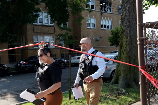 Police officers investigate the scene of an extra alarm fire early, June 26, 2025, in the Chicago&#39;s Austin neighborhood. Six people were hospitalized, three in grave condition.  (Antonio Perez/Chicago Tribune)