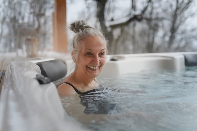 Peaceful moment for senior woman bathing in hot tub.