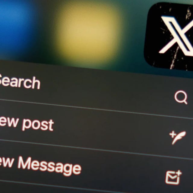 The 'X' logo on a phone screen.