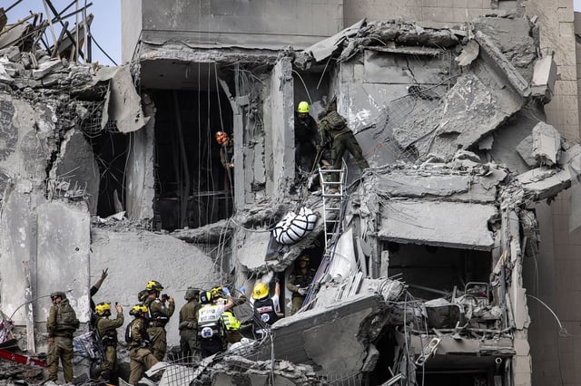 Israeli emergency services and security officers recover a body from the rubble of a building hit by an Iranian missile in Beer Sheva in southern Israel on Tuesday.