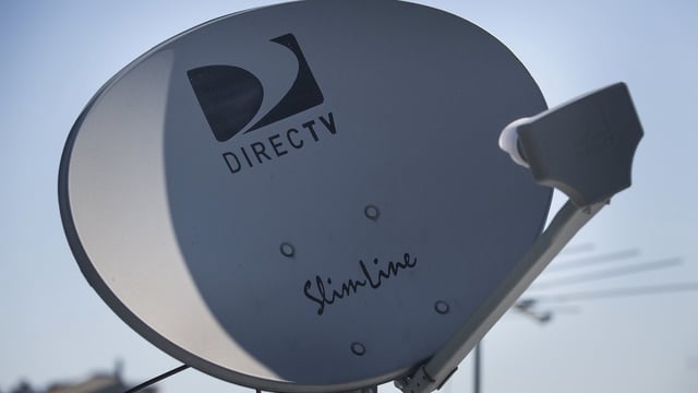 A DirecTV sattelite dish sits on a roof on May 19, 2014 in New York City. (Photo by Andrew Burton/Getty Images)