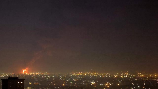 Flames from a fire at the Tehran oil refinery, located south of the capital, are seen burning in the distance on June 15 (AFP FILE)