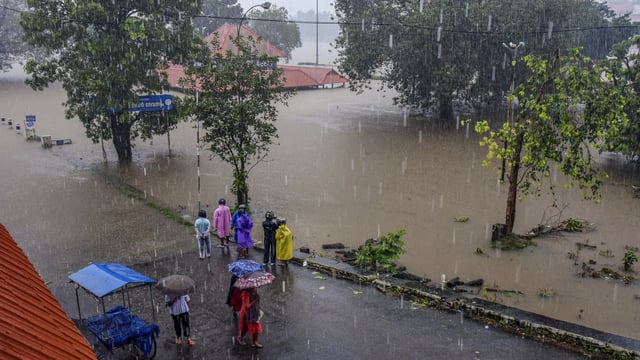 Ernakulam: Pedestrians look on as the water level of the Periyar river increased following heavy rainfall, at Aluva in Ernakulam district of Kerala, Thursday, June 26, 2025. 