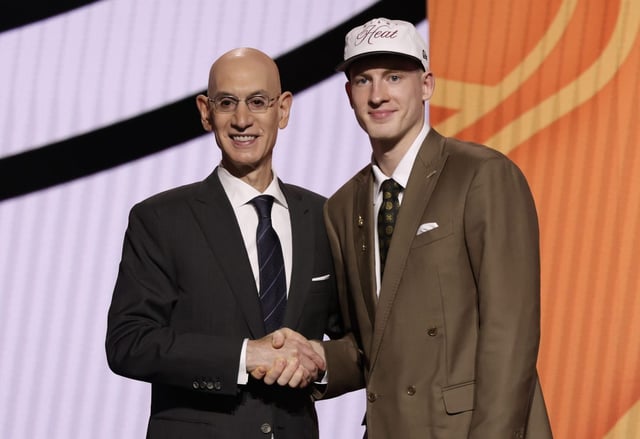 Illinois guard Kasparas Jakucionis poses for a photo with NBA commissioner Adam Silver after being selected 20th by the Miami Heat in the first round of the NBA basketball draft, Wednesday, June 25, 2025, in New York. (AP Photo/Adam Hunger)