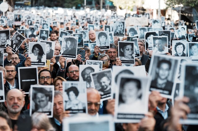 People hold images of the victims of the 1994 bombing attack on the Argentine Israeli Mutual Association (AMIA) community centre, marking the 30th anniversary of the attack, in Buenos Aires, Argentina July 18, 2024. REUTERS/Irina Dambrauskas/File Photo