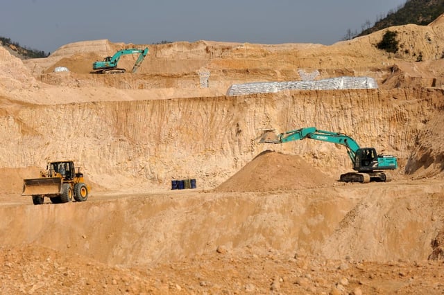 Workers dig at a rare earth mine in central China’s Jiangxi province. Photo: Chinatopix via AP