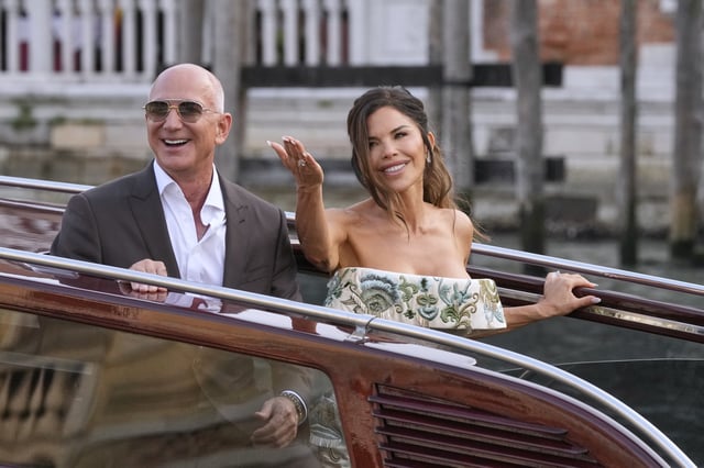 Jeff Bezos, left, and Lauren Sanchez leave a hotel for their pre-wedding reception, in Venice, Italy, Thursday, June 26, 2025. (AP Photo/Luca Bruno)