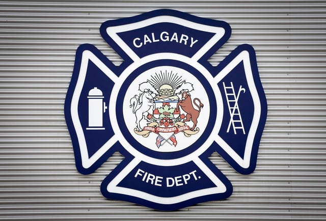 A logo of the Calgary Fire Department is pictured on its headquarters building in Calgary, Thursday, March 20, 2025. Two people were killed, including a nine-year-old girl, in an early morning house fire east of the Calgary airport. THE CANADIAN PRESS/Jeff McIntosh