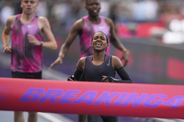 Faith Kipyegon, from Kenya, approaches the finish line in her attempt to become the first woman to run a mile in under four minutes.