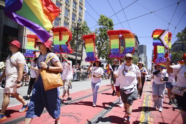 Revelers walk along Market Street during a Pride Parade, Sunday, June 30, 2024, in San Francisco.