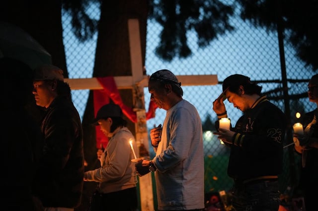 People gather for a candlelight march during a vigil on the street where a vehicle-ramming attack occurred at the Filipino community's Lapu Lapu Day festival last week, on a provincial day of mourning for the victims, in Vancouver, B.C., Friday, May 2, 2025. 