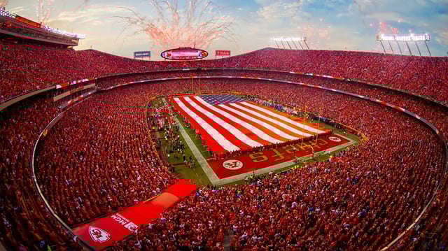 A giant American flag and fireworks fill the sky during the opening ceremonies for the home opener game between the Kansas City Chiefs and the LA Chargers on Thursday September 15, 2022 at Arrowhead Stadium in Kansas City, Missouri