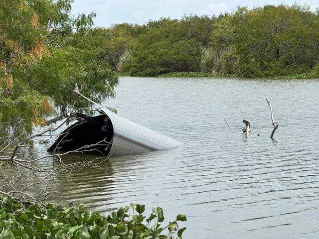 Debris from a SpaceX spacecraft lies partially submerged in the Rio Grande River, as seen from Matamoros, Mexico, June 19, 2025. REUTERS/Abraham Pineda/File Photo