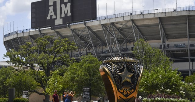 People take photos with the 3-ton bronze replica of the Haynes Aggie Ring at Texas A&M University on Monday, June 15, 2020 in College Station. The ring is located outside the Clayton W. Williams Jr. Alumni Center near Kyle Field.