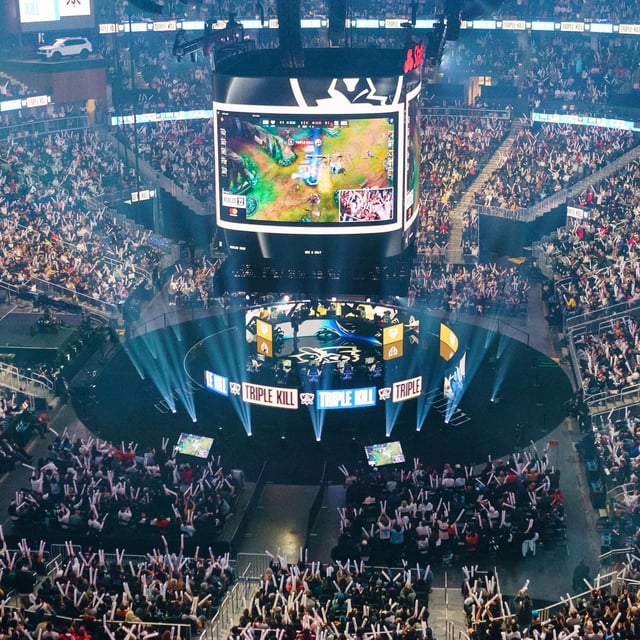 TOPSHOT - Attendees cheer and wave inflatable batons as they watch DRX compete against GEN during the League of Legends Worlds Championship semifinals at State Farm Arena in Atlanta, Georgia on October 30, 2022. (Photo by Elijah Nouvelage / AFP) (Photo by ELIJAH NOUVELAGE/AFP via Getty Images)