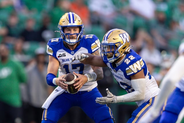 Chris Streveler #17 fakes a hand off to Matthew Peterson #22 of the Winnipeg Blue Bombers in the pre-season game between the Winnipeg Blue Bombers and Saskatchewan Roughriders at Mosaic Stadium on May 30, 2025 in Regina, Canada.