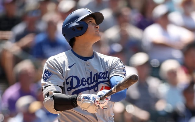Dodgers star Shohei Ohtani hits a solo home run during the seventh inning of their game against the Colorado Rockies on Thursday afternoon in Denver. Ohtani led all National League players in votes for the All-Star Game by the end of Phase 1 voting. That gives him an automatic spot in the starting lineup for the July 15 game in Atlanta. (Photo by Matthew Stockman/Getty Images)