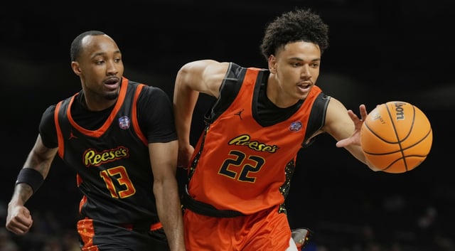 The West team’s Kobe Sanders (Nevada) reaches for a loose ball in front of the East’s Tamar Bates (Missouri) during the first half of a college all-star game at the Final Four on Friday, April 4, 2025, in San Antonio. (AP Photo/Eric Gay)