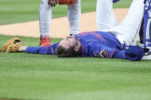 Jun 26, 2025; New York City, New York, USA;  New York Mets starting pitcher Griffin Canning (46) lays on the ground after getting injured in the third inning against the Atlanta Braves at Citi Field. Mandatory Credit: Wendell Cruz-Imagn Images