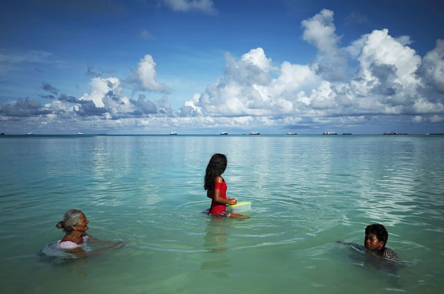 People swim in the lagoon in Funafuti, Tuvalu, on November 28, 2019.