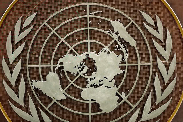The logo of the United Nations is seen in the General Assembly hall before heads of state begin to address the 76th Session of the U.N. General Assembly in New York City, U.S., September 21, 2021.  REUTERS/Eduardo Munoz/Pool/File photo