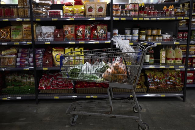 FILE - A shopping cart filled with groceries sits in an aisle at an Asian grocery store in Rowland Heights, Calif., Thursday, April 3, 2025. (AP Photo/Jae C. Hong, File)