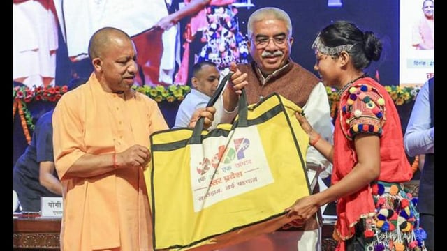 Chief minister Yogi presents toolkit to a beneficiary of ‘One District, One Product’ scheme during the curtain raiser ceremony of the third edition of the UP International Trade Show (UPITS) on the occasion of International MSME Day, at Lok Bhavan, in Lucknow, Friday. (PTI Photo)