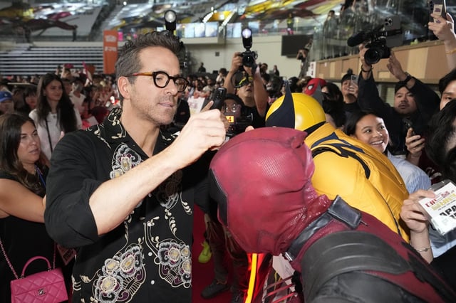 Actor Ryan Reynolds signs autograph during a red carpet event to promote his movie "Deadpool and Wolverine" in Seoul, South Korea on Thursday, July 4, 2024. (AP Photo/Ahn young-joon)
