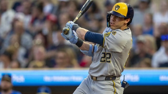 Jun 20, 2025; Minneapolis, Minnesota, USA; Milwaukee Brewers designated hitter Christian Yelich (22) hits a RBI single against the Minnesota Twins in the sixth inning at Target Field. Mandatory Credit: Jesse Johnson-Imagn Images