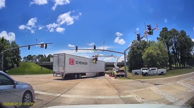 An 18-wheel semi truck hit an electrical worker in Louisiana, leaving him dangling upside down above the road.