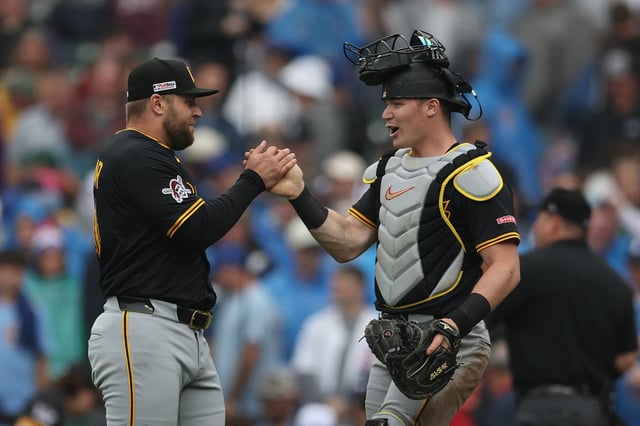 CHICAGO, ILLINOIS - JUNE 13: David Bednar #51 and Henry Davis #32 of the Pittsburgh Pirates celebrate their team&#39;s win against the Chicago Cubs at Wrigley Field on June 13, 2025 in Chicago, Illinois.