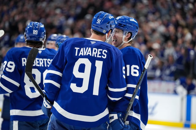Toronto Maple Leafs' Mitch Marner (16) is congratulated by teammate John Tavares (91) after scoring the game winning goal against the Montreal Canadiens during overtime NHL hockey action in Toronto on Saturday, April 12, 2025.