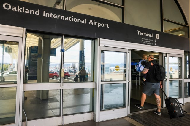 Trravelers walk in Terminal 1 of the Oakland International Airport in Oakland, Calif., on Friday, April 12, 2024. On Thursday, the Oakland Board of Port Commissioners voted unanimously, 7-0, to approve the name change to San Francisco Bay Oakland International Airport. But San Francisco International Airport officials have expressed dismay about the name change and some San Francisco officials have threatened a lawsuit to block the move. (Ray Chavez/Bay Area News Group)