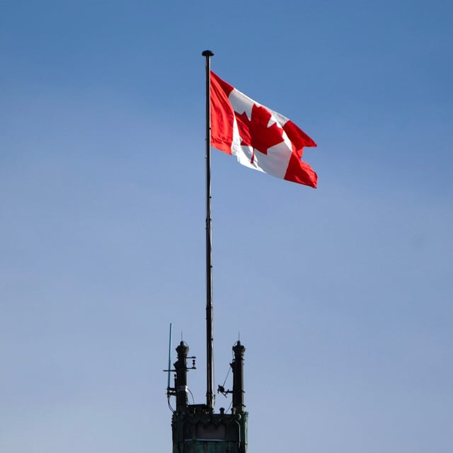 The Canadian flag flies over the Peace Tower on Parliament Hill, Friday, Feb. 14, 2025 in Ottawa.  THE CANADIAN PRESS/Adrian Wyld