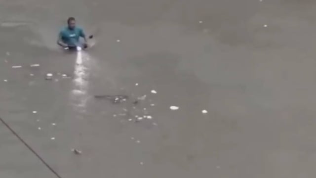  A man riding a two-wheeler through submerged streets | Image: X