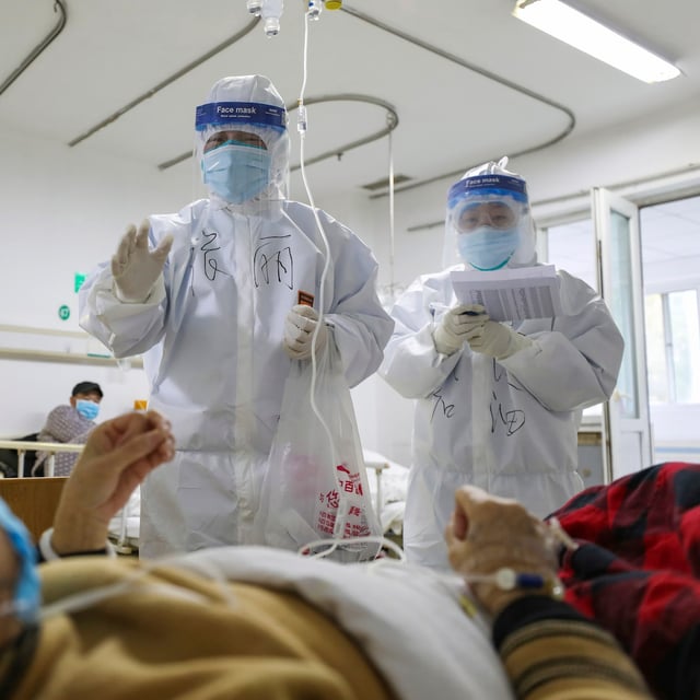 FILE - Medical workers check on patients in Jinyintan Hospital, designated for critical condition COVID-19 patients, in Wuhan, central China's Hubei province, Feb. 13, 2020. (Chinatopix Via AP, File)