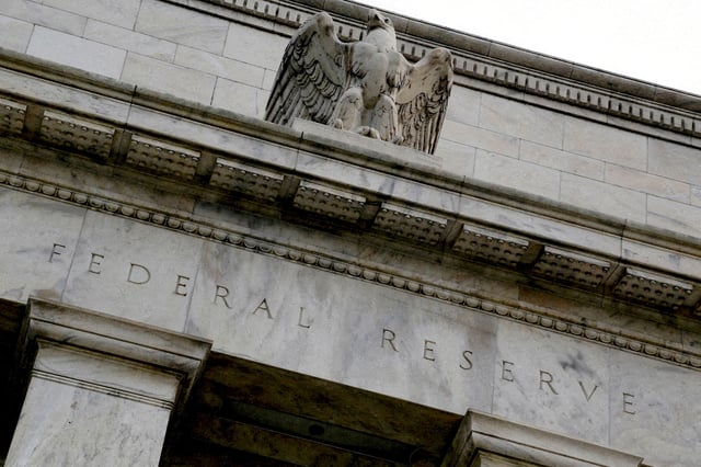 An eagle tops the U.S. Federal Reserve building's facade in Washington, July 31, 2013. REUTERS/Jonathan Ernst/File Photo