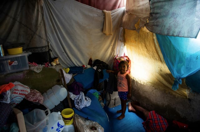 A child stands in a temporary shelter near the National Palace in Port-au-Prince, Haiti, on June 6, 2025