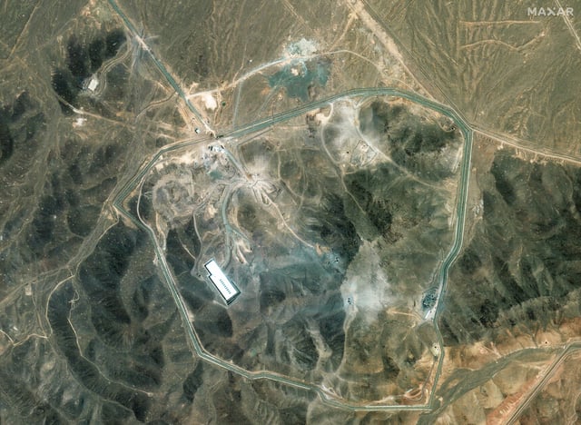 Wide view of Fordow enrichment complex showing recent excavation patterns and a trail of disturbed soil, indicating active recovery efforts.