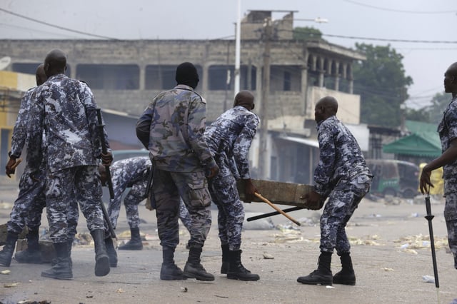 Police remove a barricade set up by demonstrators during a protest calling for President Faure Gnassingbe's resignation in Lome, Togo, Thursday, June 26, 2025. (AP Photo/Erick Kaglan)