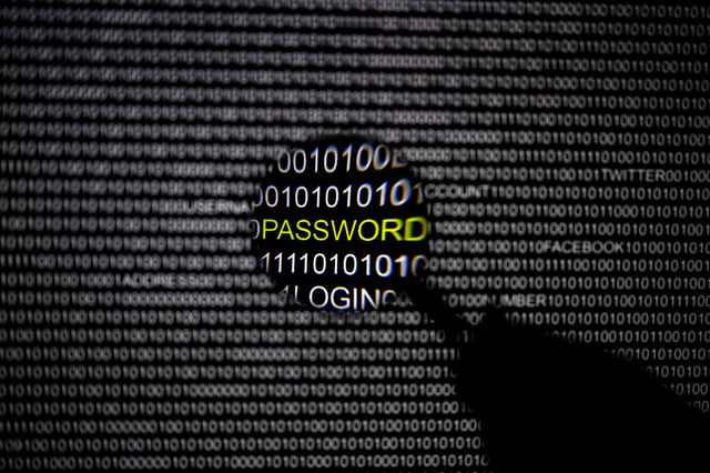 A magnifying glass is held in front of a computer screen in this picture illustration taken in Berlin May 21, 2013. REUTERS/Pawel Kopczynski/Illustration/File Photo