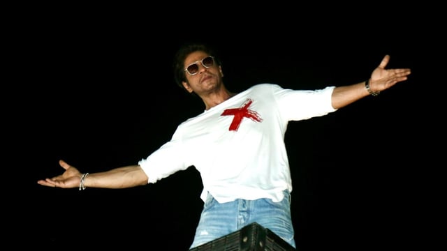Shah Rukh Khan often greets his fans who were gathered outside his home at Mannat with his iconic pose. (ANI Photo)