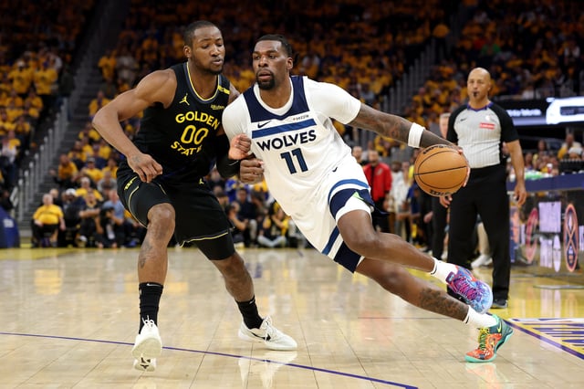 Naz Reid #11 of the Minnesota Timberwolves dribbles the ball against Jonathan Kuminga #00 of the Golden State Warriors during the second quarter in Game Four of the Western Conference Second Round NBA Playoffs at Chase Center on May 12, 2025 in San Francisco, California.