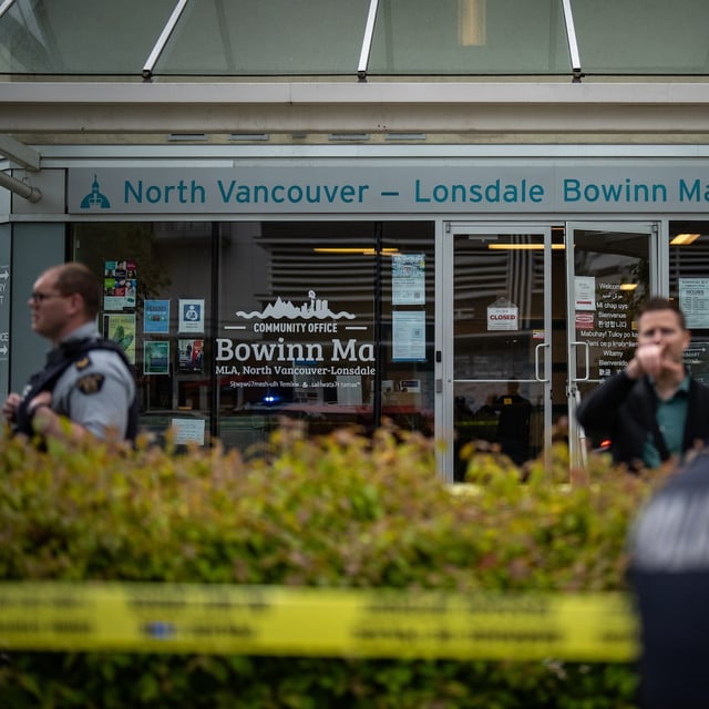 RCMP officers direct pedestrians from North Vancouver - Lonsdale MLA Bowinn Ma's office after an explosion early in the morning in North Vancouver, B.C. on Friday, June 27, 2025. THE CANADIAN PRESS/Ethan Cairns