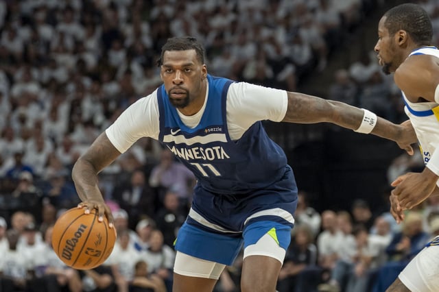 Minnesota Timberwolves center Naz Reid dribbles the ball against the Golden State Warriors during a 2025 NBA Playoff game in Minneapolis on May 14, 2025.
