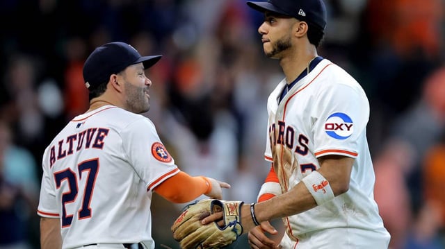Houston Astros teammates Jose Altuve (L) and Jeremy Peña