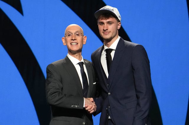 US basketball player Cooper Flagg (R) shakes hands with NBA Commissioner Adam Silver after being selected first overall by the Dallas Mavericks during the opening round of the 2025 NBA Draft at Barclays Center in Brooklyn, New York, on June 25, 2025.